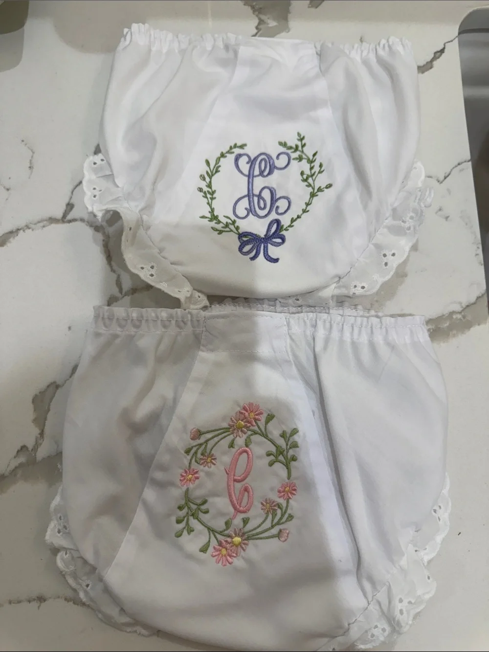 Pair of IC COLLECTIONS White Ruffle Diaper Covers w/ “C” Floral Monograms